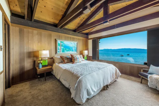 a spacious bedroom with a bed and a dresser