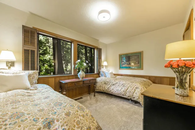 a bedroom with a large bed and a large window