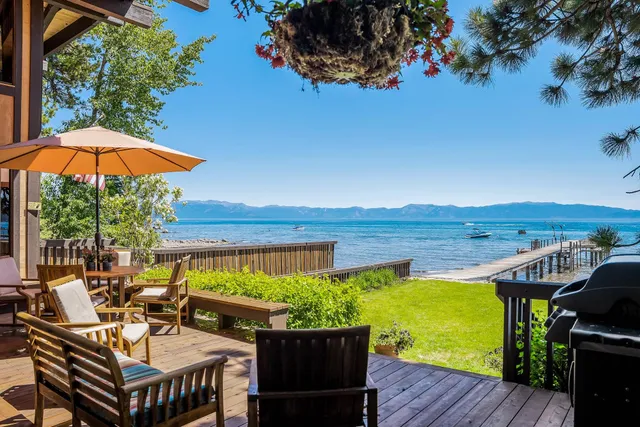 a view of a balcony with wooden floor and outdoor seating