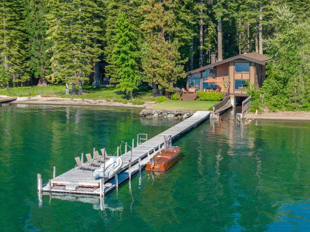 a balcony with chairs and lake view
