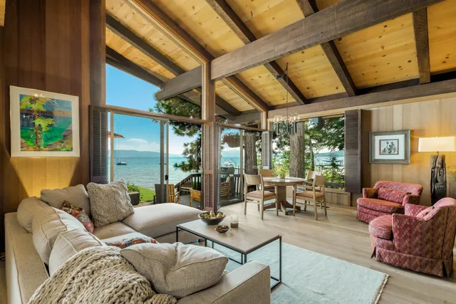 a living room with furniture and large windows