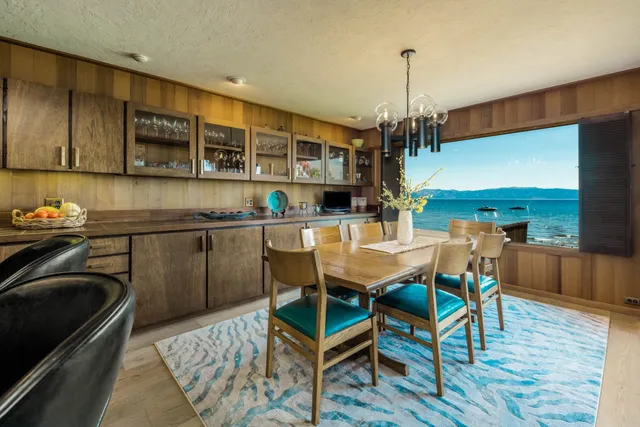 a kitchen with stainless steel appliances granite countertop a stove top oven a sink dishwasher and cabinets with wooden floor