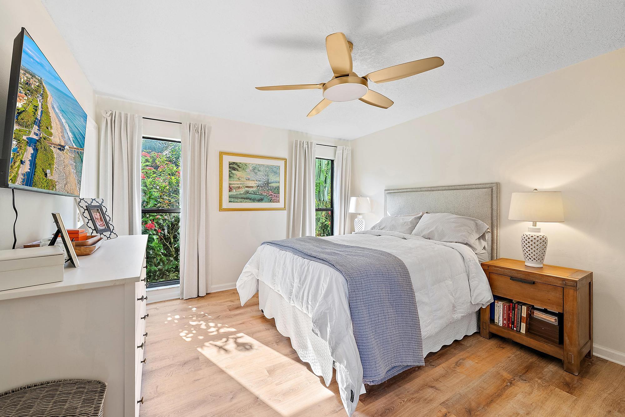 16766 123rd Terrace North Jupiter, FL 33478 - Photo 13 of 26 a bedroom with a bed and a chandelier