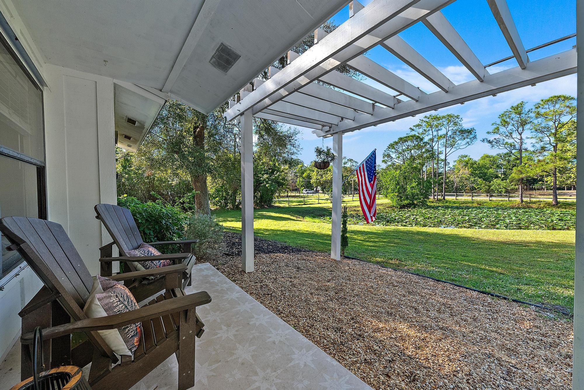 16766 123rd Terrace North Jupiter, FL 33478 - Photo 18 of 26 a view of a house with backyard and porch