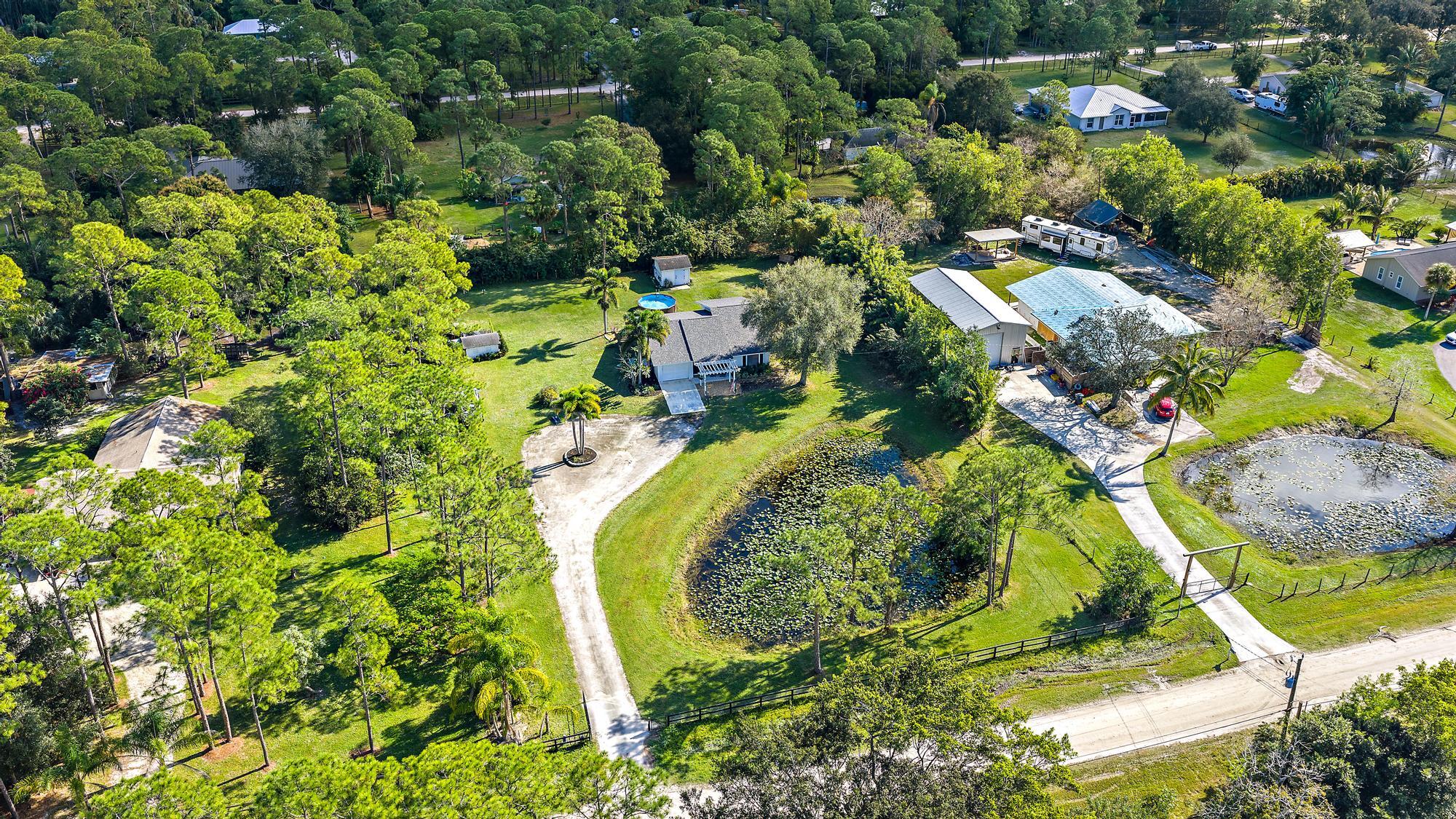 16766 123rd Terrace North Jupiter, FL 33478 - Photo 23 of 26 an aerial view of residential house with swimming pool and green space