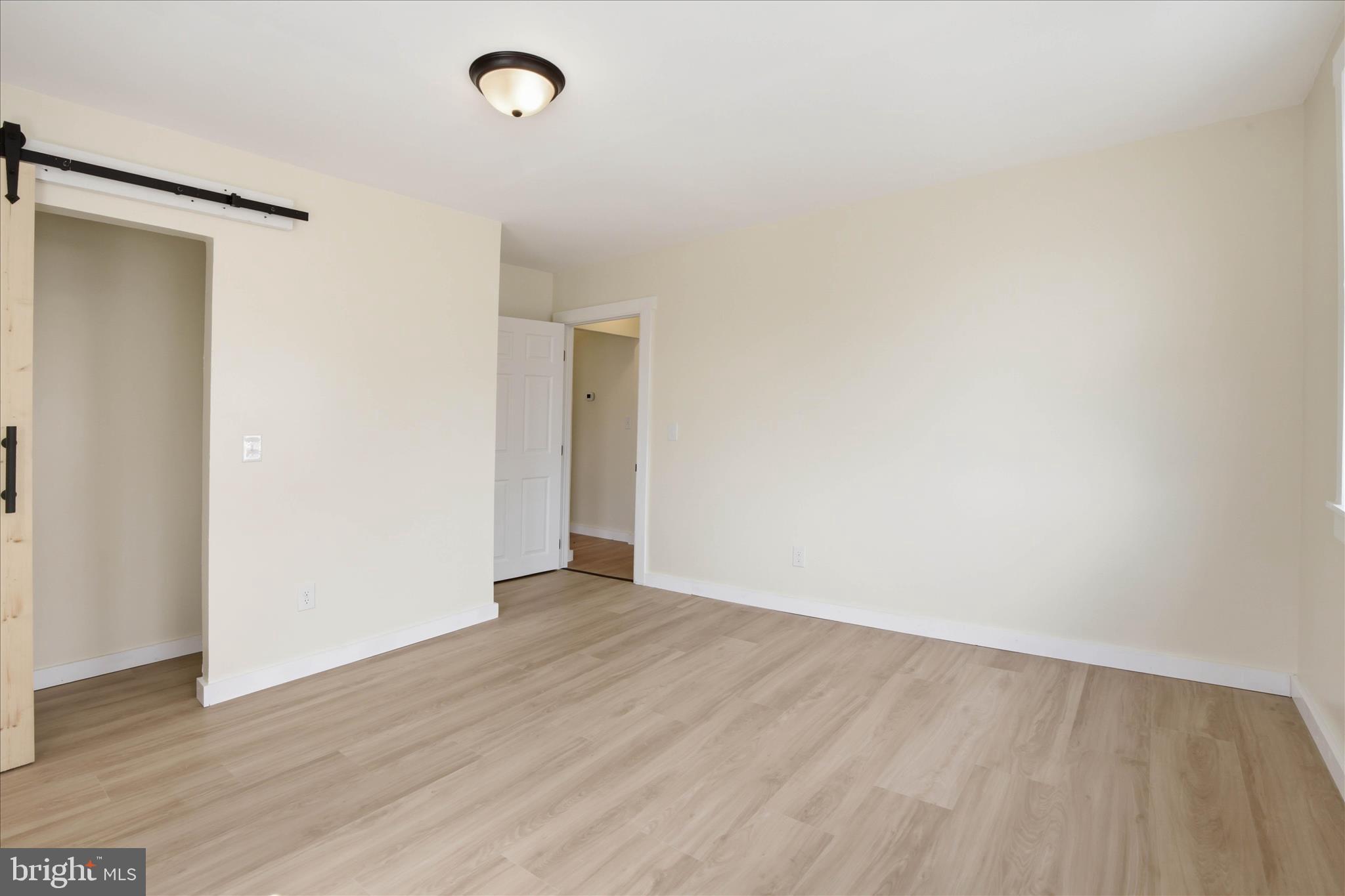101 East Lincoln Avenue Lititz, PA 17543 - Photo 22 of 39 a view of an empty room with wooden floor and a window