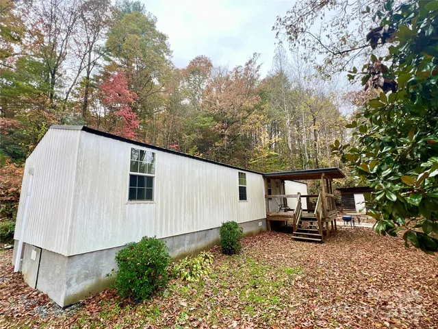 a view of house with backyard and trees