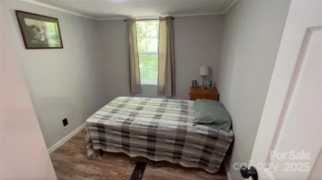 a bed sitting in a bedroom next to a window