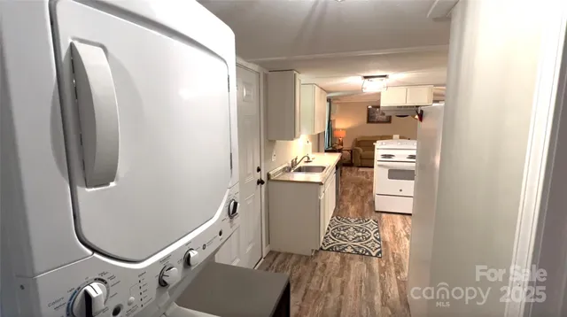 a kitchen with white cabinets and refrigerator