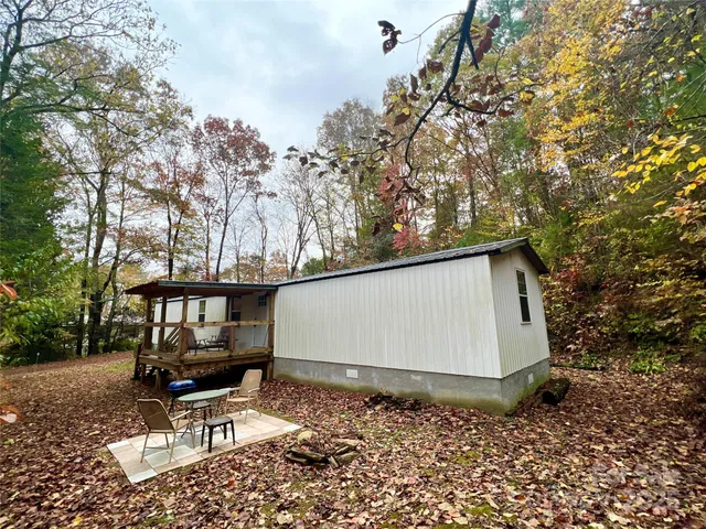 a backyard of a house with table and chairs