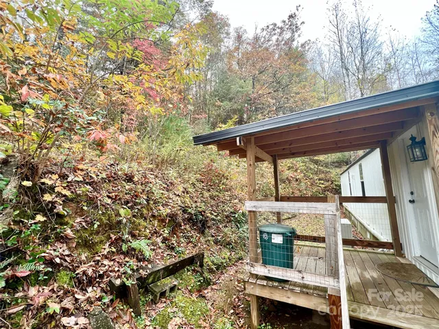 a view of backyard with a small space and deck