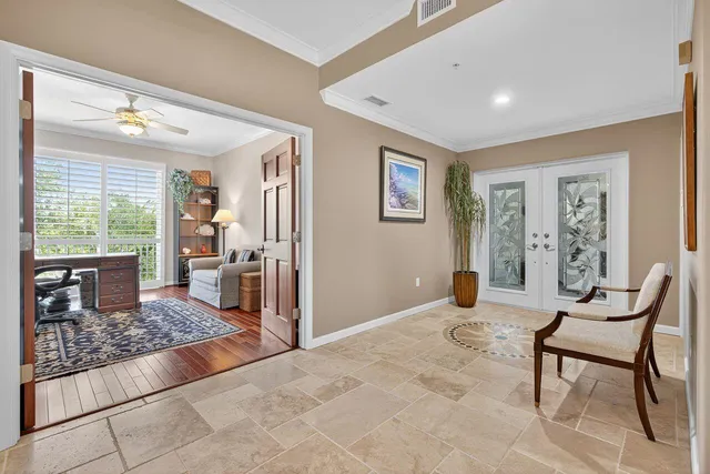 a kitchen with stainless steel appliances kitchen island granite countertop a table chairs sink and cabinets