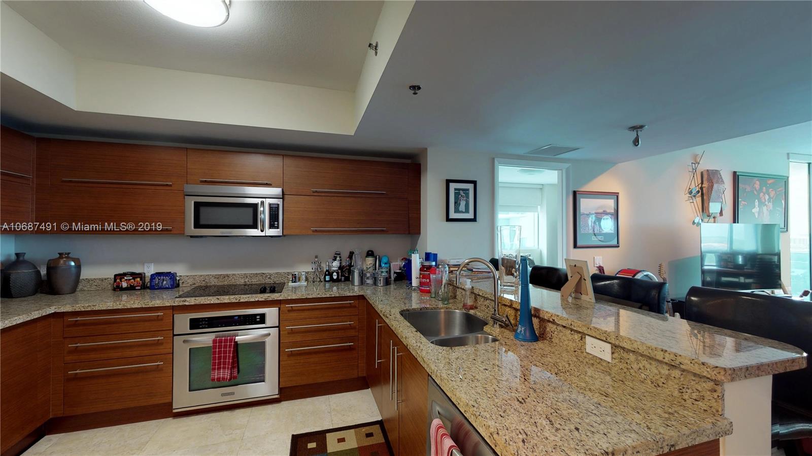 2641 North Flamingo Road, Unit 1401N Plantation, FL 33323 - Photo 20 of 49 a kitchen with stainless steel appliances granite countertop a sink dishwasher stove and oven