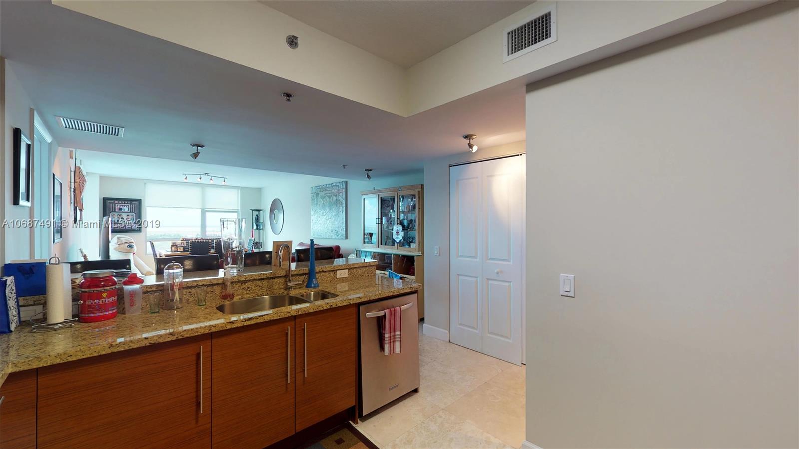 2641 North Flamingo Road, Unit 1401N Plantation, FL 33323 - Photo 22 of 49 a kitchen with granite countertop a sink and cabinets