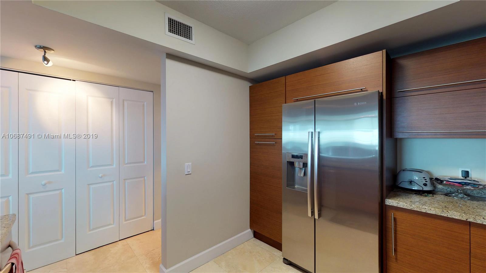 2641 North Flamingo Road, Unit 1401N Plantation, FL 33323 - Photo 24 of 49 a kitchen with stainless steel appliances granite countertop a refrigerator and a sink