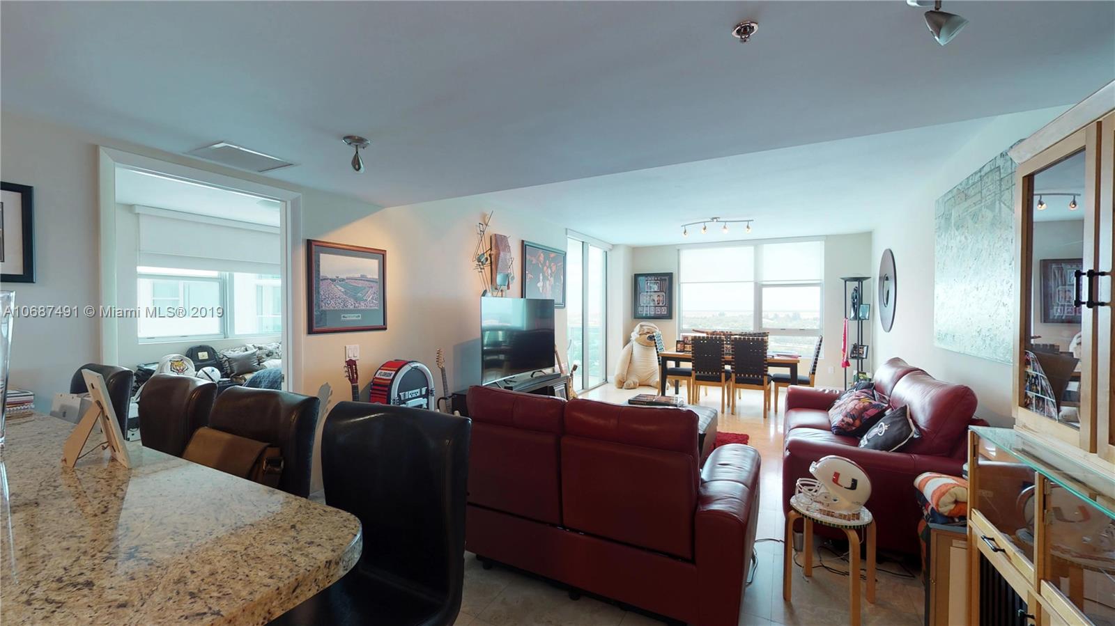 2641 North Flamingo Road, Unit 1401N Plantation, FL 33323 - Photo 26 of 49 a living room with furniture a wooden floor and a window