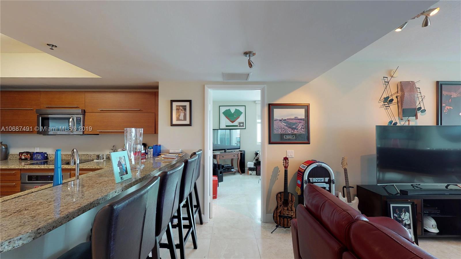 2641 North Flamingo Road, Unit 1401N Plantation, FL 33323 - Photo 27 of 49 a living room with fireplace furniture and a flat screen tv