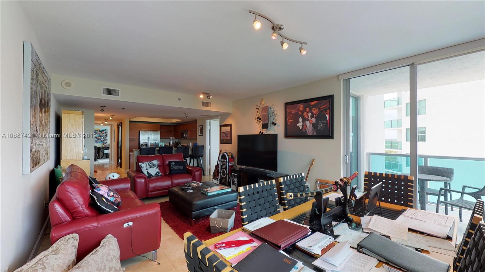 2641 North Flamingo Road, Unit 1401N Plantation, FL 33323 - Photo 31 of 49 a living room with furniture and a flat screen tv