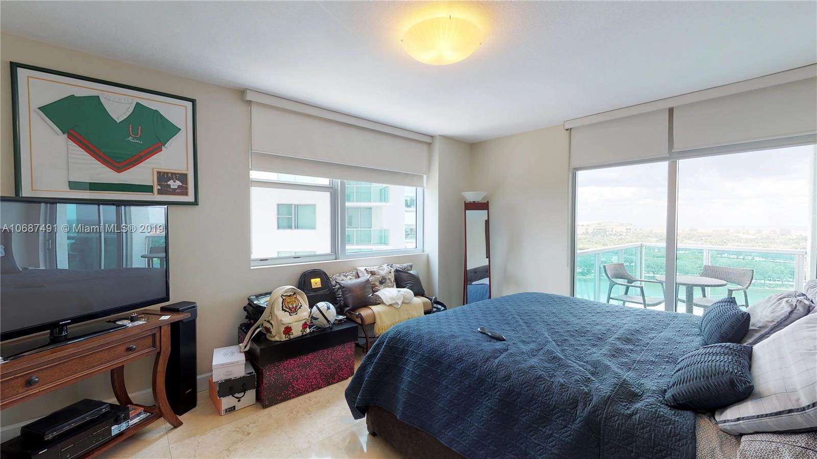 2641 North Flamingo Road, Unit 1401N Plantation, FL 33323 - Photo 33 of 49 a bedroom with a bed and wooden floor