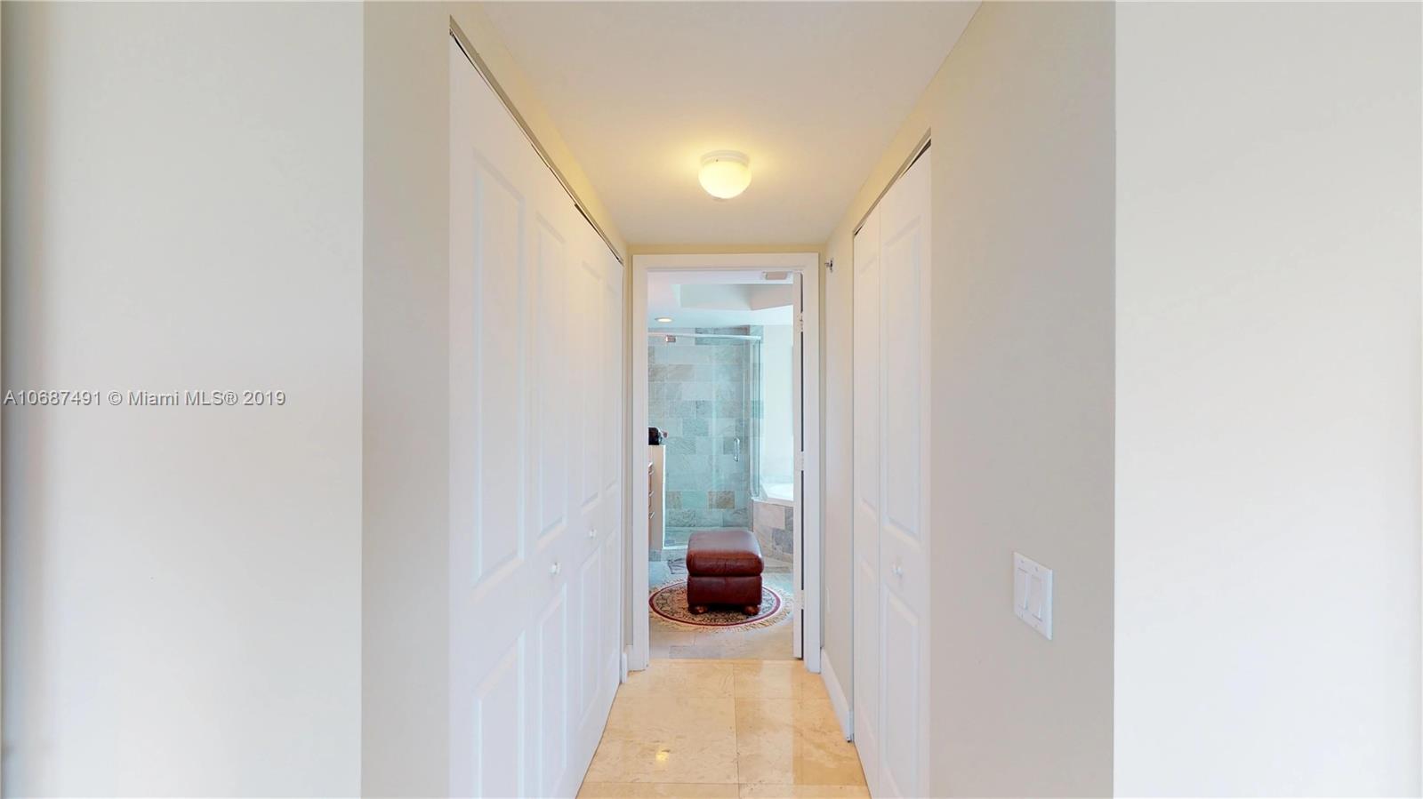2641 North Flamingo Road, Unit 1401N Plantation, FL 33323 - Photo 35 of 49 a view of a hallway with wooden floor and a bathroom