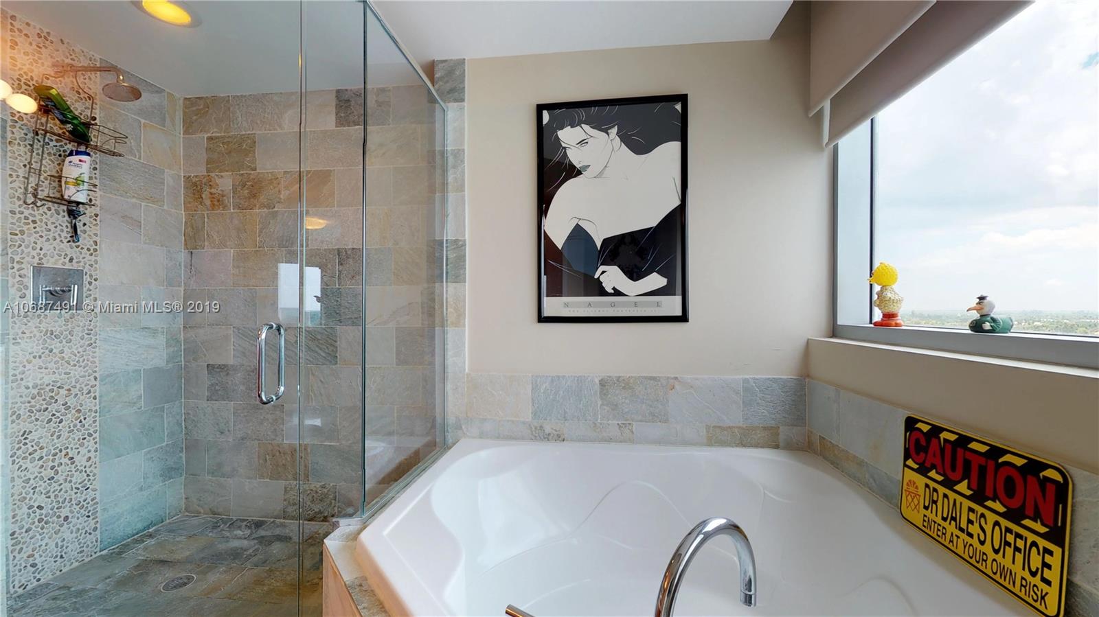 2641 North Flamingo Road, Unit 1401N Plantation, FL 33323 - Photo 37 of 49 a bathroom with a bathtub and a shower