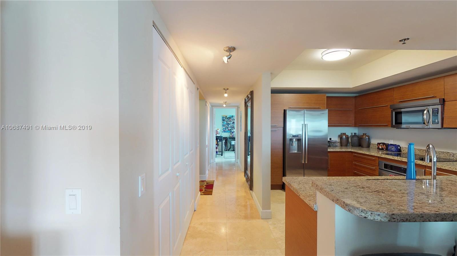 2641 North Flamingo Road, Unit 1401N Plantation, FL 33323 - Photo 39 of 49 a kitchen with stainless steel appliances granite countertop a sink and a refrigerator