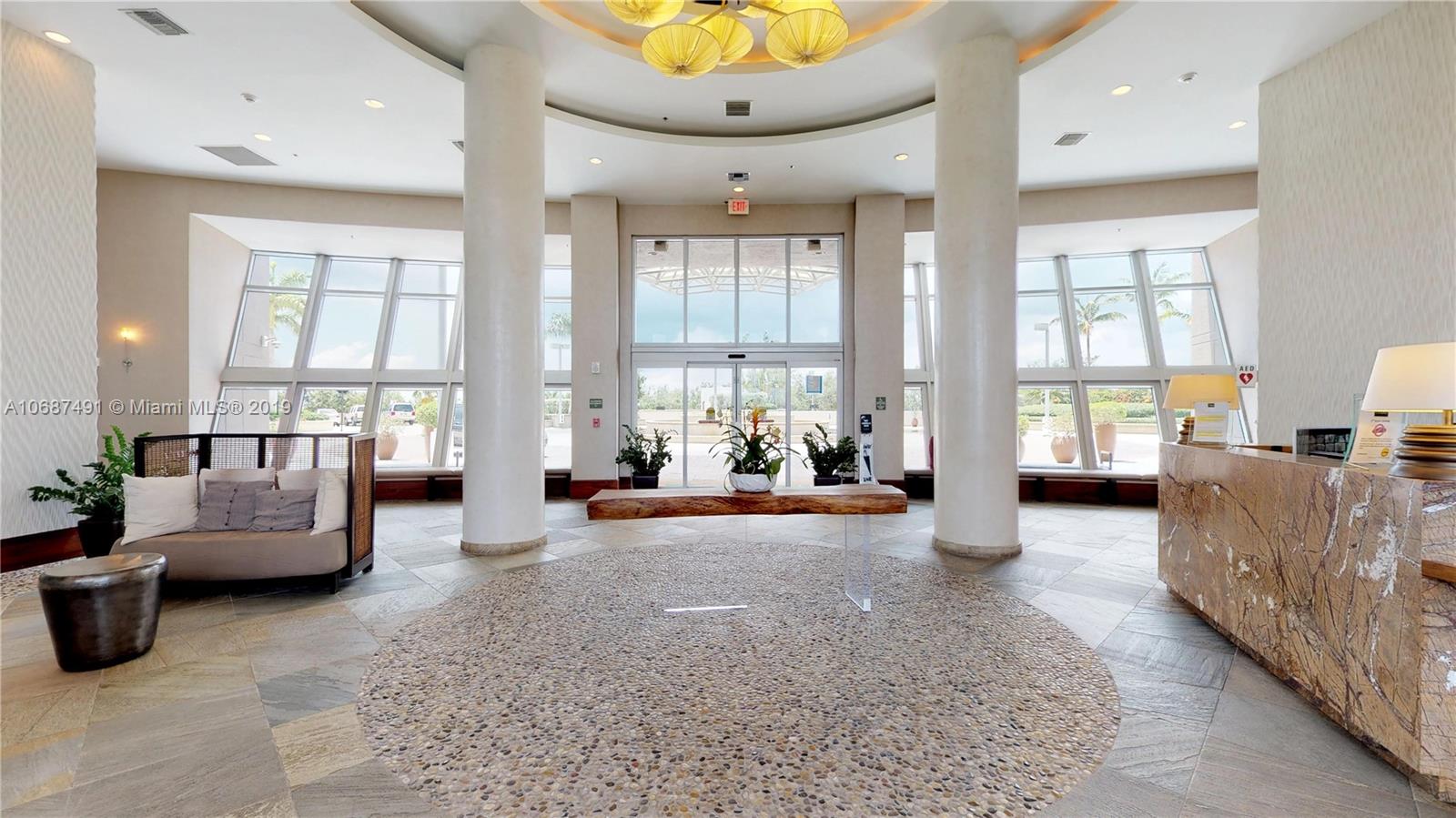 2641 North Flamingo Road, Unit 1401N Plantation, FL 33323 - Photo 4 of 49 a living room with furniture and a large window