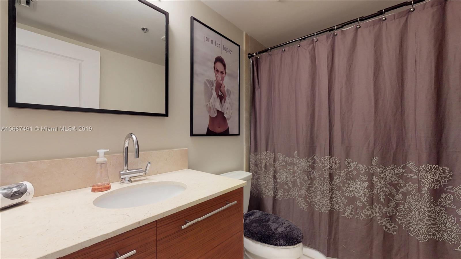 2641 North Flamingo Road, Unit 1401N Plantation, FL 33323 - Photo 41 of 49 a bathroom with a sink vanity and a mirror
