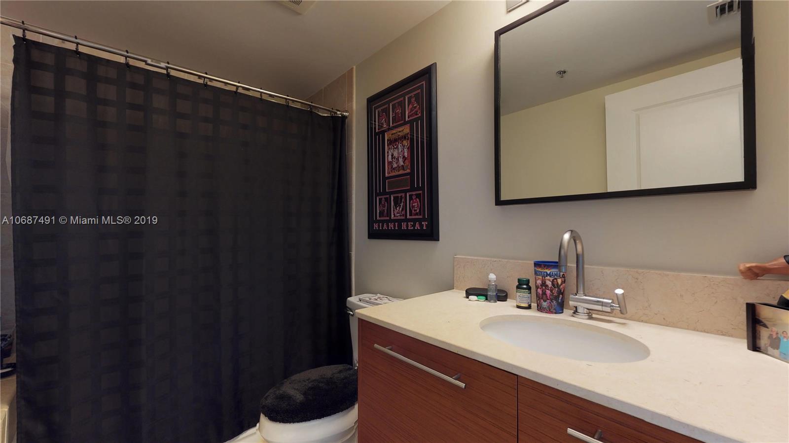 2641 North Flamingo Road, Unit 1401N Plantation, FL 33323 - Photo 46 of 49 a bathroom with a sink and a mirror