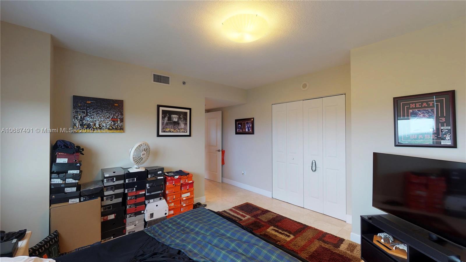 2641 North Flamingo Road, Unit 1401N Plantation, FL 33323 - Photo 49 of 49 a living room with furniture and a flat screen tv