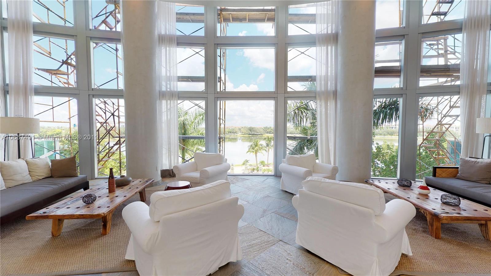 2641 North Flamingo Road, Unit 1401N Plantation, FL 33323 - Photo 5 of 49 a living room with furniture and floor to ceiling windows