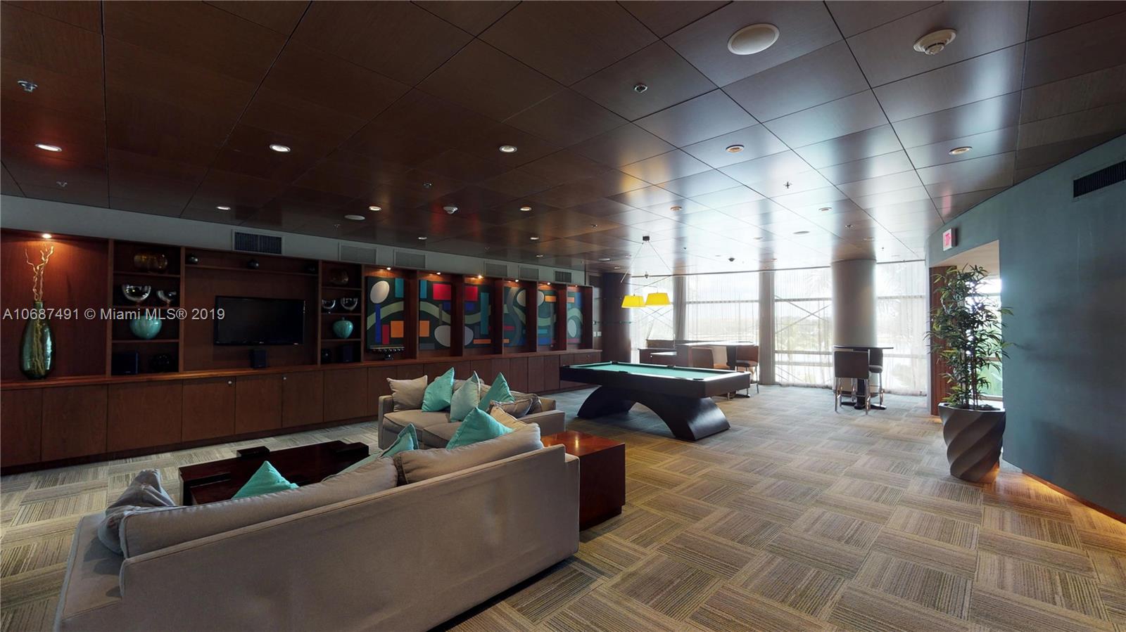 2641 North Flamingo Road, Unit 1401N Plantation, FL 33323 - Photo 9 of 49 a living room with furniture and a flat screen tv