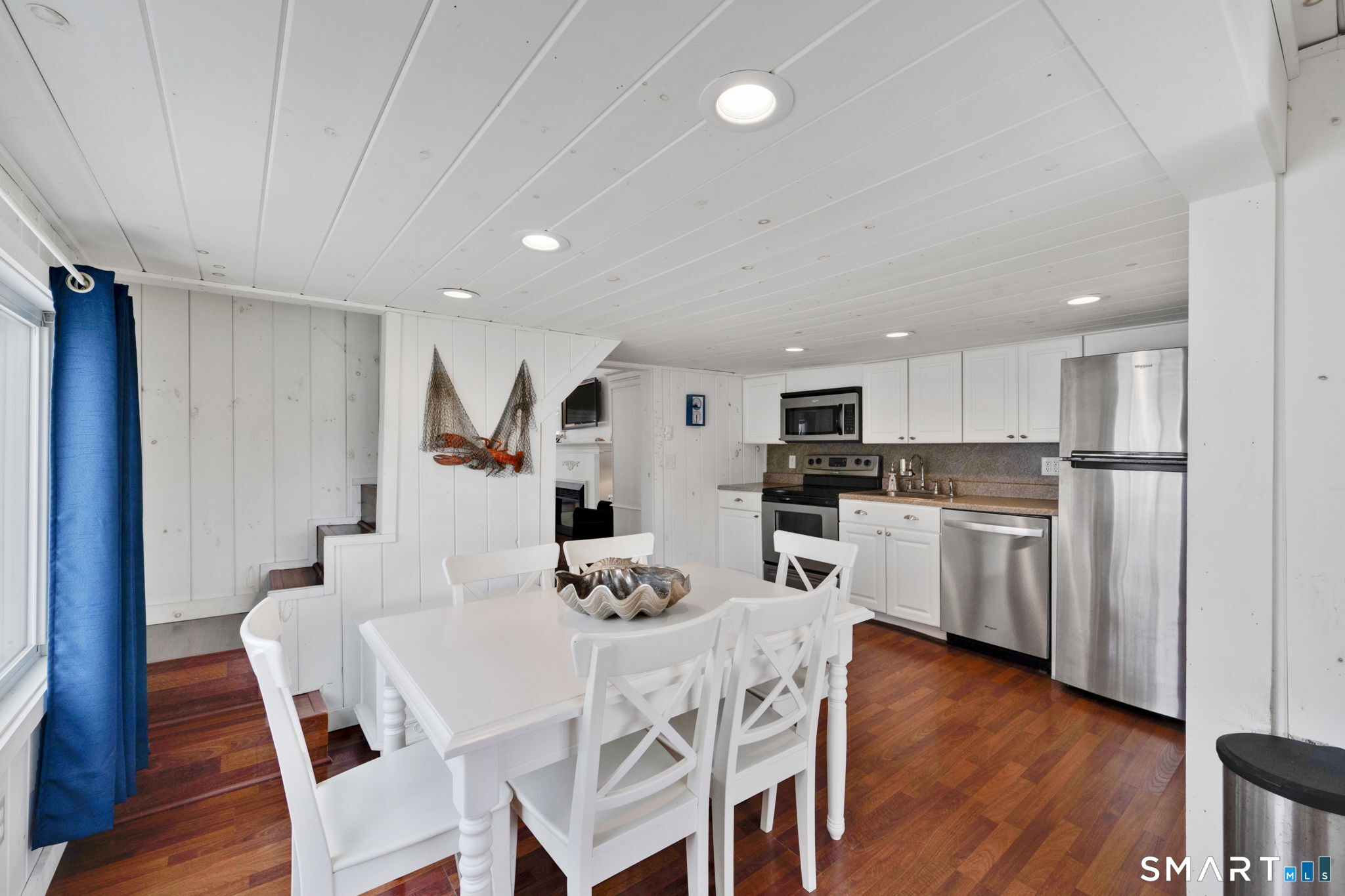 96 Chalker Beach Road Old Saybrook, CT 06475 - Photo 14 of 33 a kitchen with white cabinets and stainless steel appliances