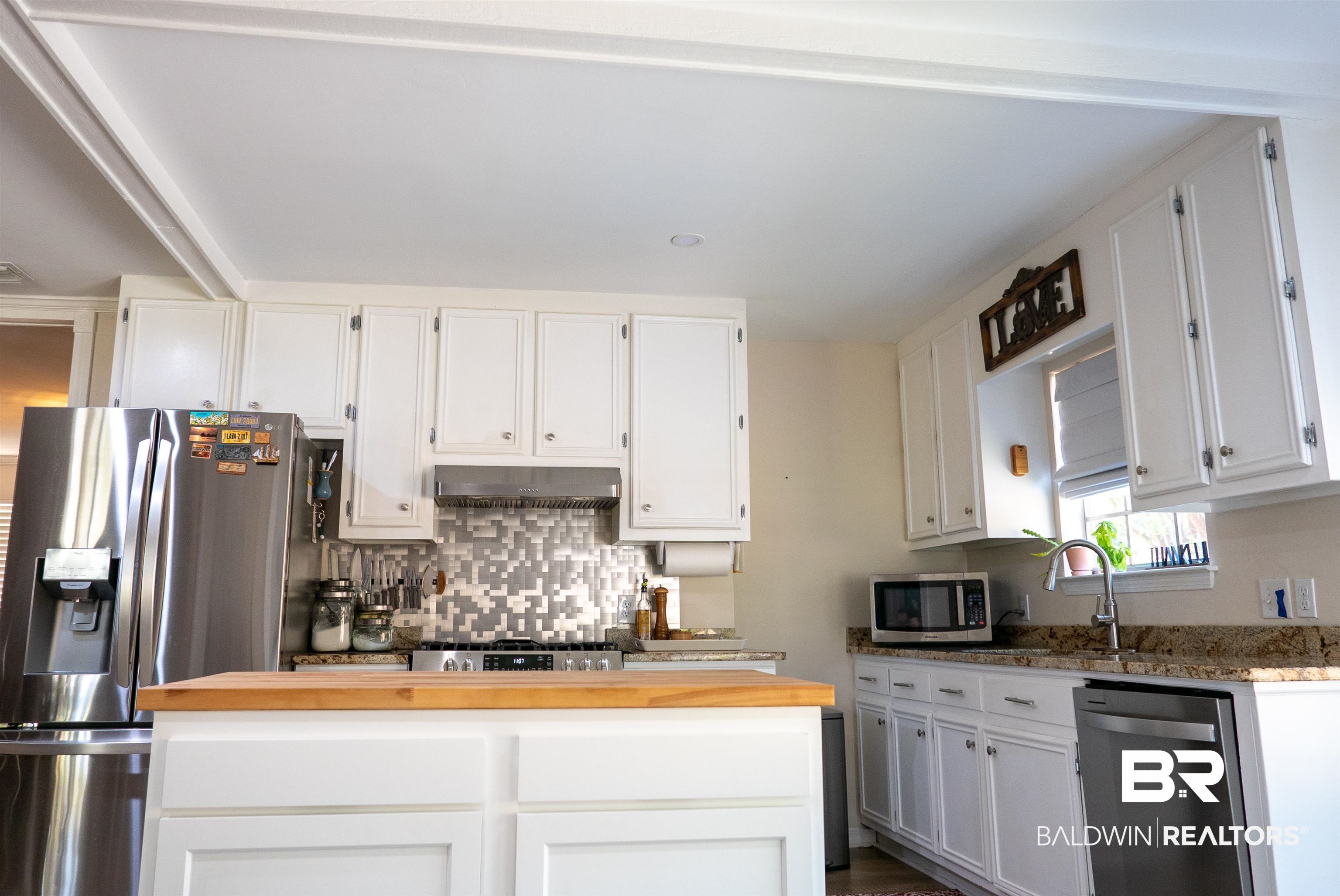 630 Spanish Main Daphne, AL 36527 - Photo 6 of 40 Kitchen featuring exhaust hood, wood counters, appliances with stainless steel finishes, and white cabinets