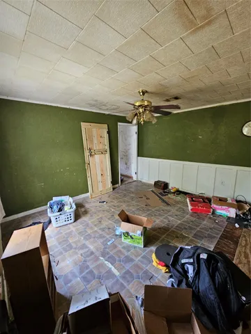 a view of a dining room with furniture and a chandelier fan