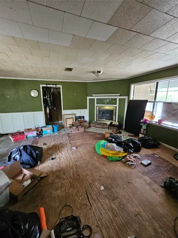 a living room with furniture pool table and a flat screen tv