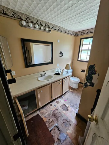 a bathroom with a sink a mirror and a toilet