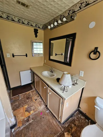 a bathroom with a sink mirror vanity and toilet