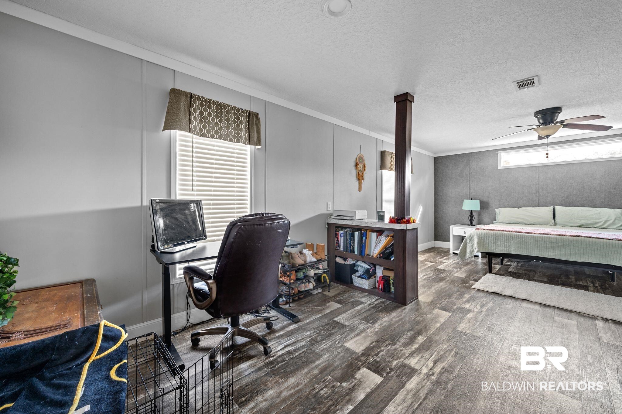 9382 D'Olive Street Bay Minette, AL 36507 - Photo 7 of 27 Home office with a textured ceiling, ceiling fan, dark hardwood / wood-style flooring, and crown molding