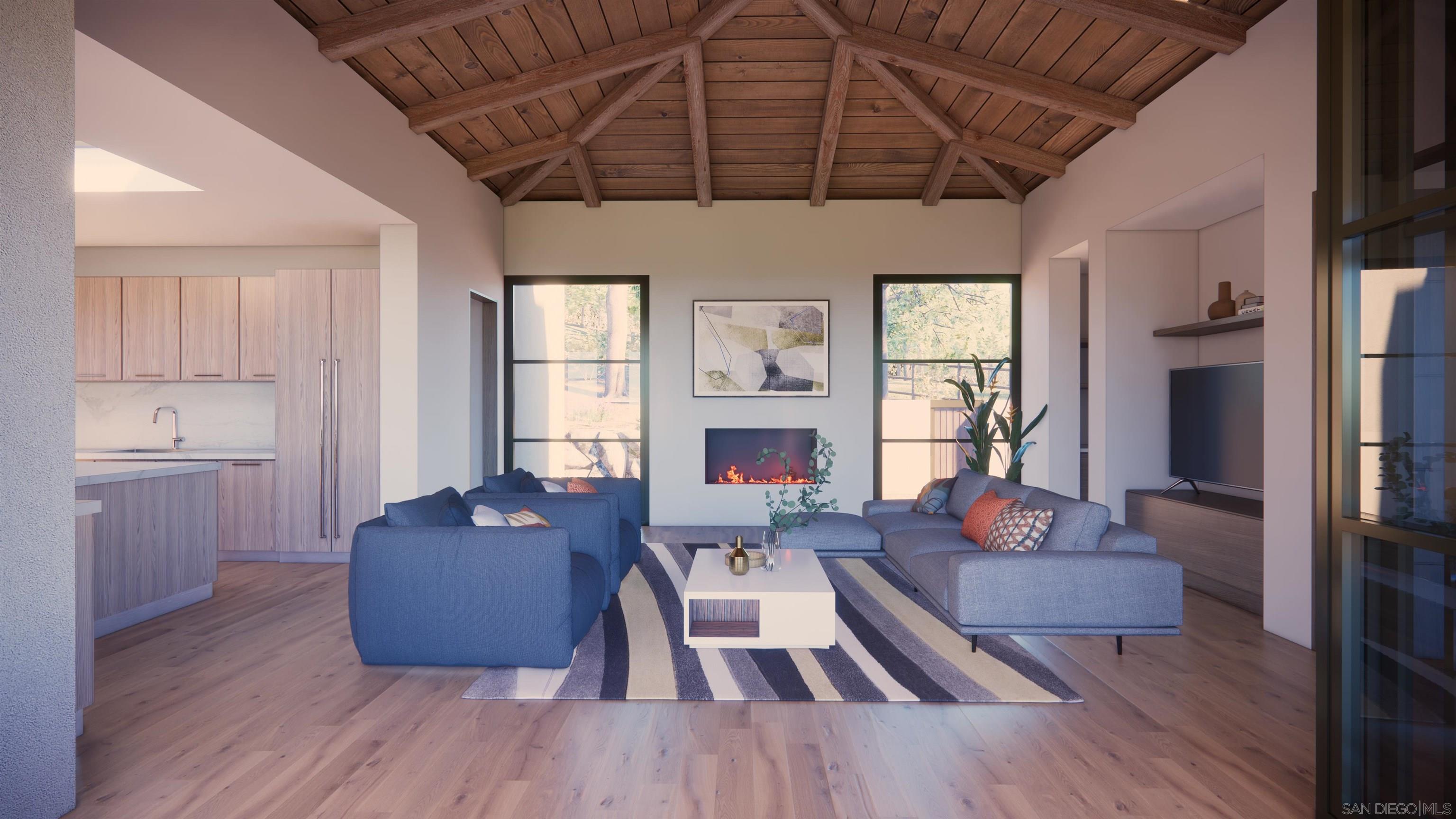 16256 Via Del Alba Rancho Santa Fe, CA 92067 - Photo 58 of 64 a living room with furniture wooden floor and a fireplace