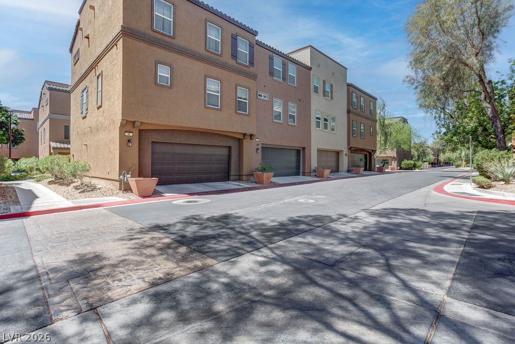 4650 Ranch House Road, Unit 47 North Las Vegas, NV 89031 - Photo 42 of 43 Attached garages and inviting sidewalks enhance these charming multi-story homes.