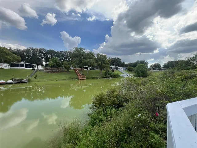 a kitchen with kitchen island granite countertop a sink appliances and cabinets