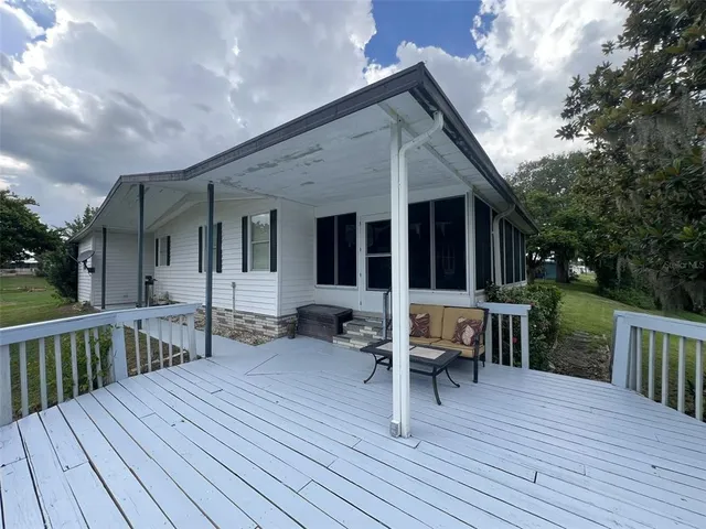 a large kitchen with granite countertop a large counter top stainless steel appliances and cabinets