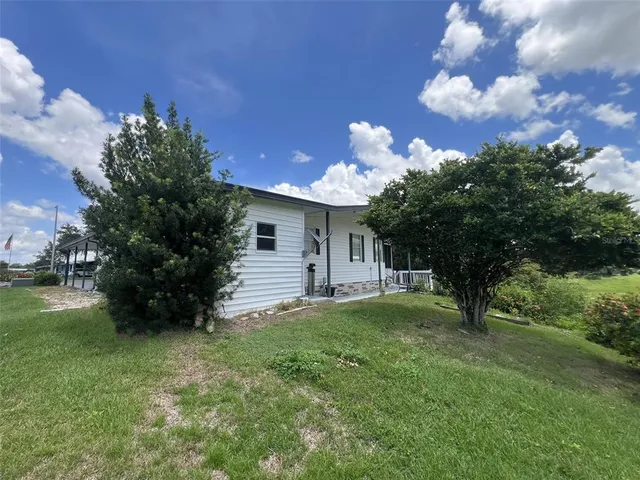 a kitchen with stainless steel appliances a refrigerator a stove a sink dishwasher a dining table and chairs with wooden floor