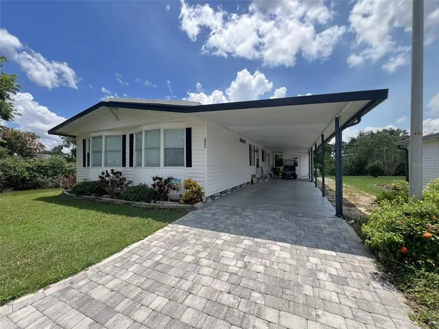 a view of a house with backyard and porch