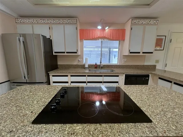 a living room with furniture gym equipment and a large window