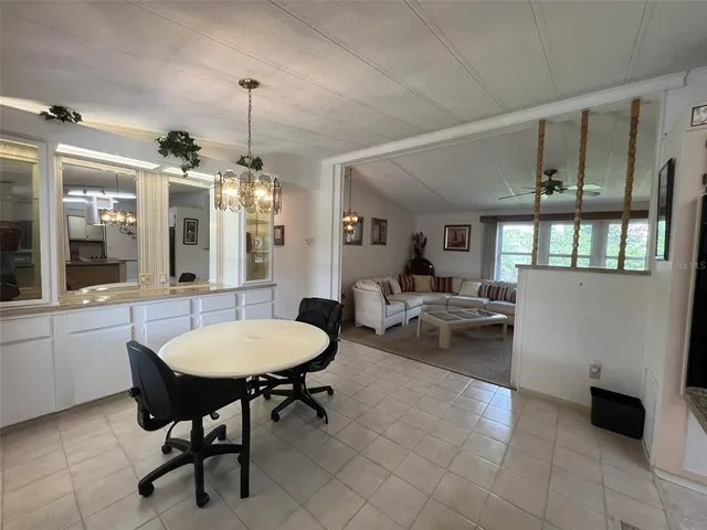 a view of a livingroom with workspace and a large window