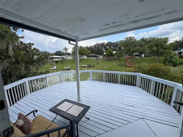 a swimming pool with outdoor seating and yard