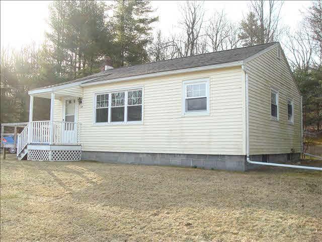 338 Slate Quarry Road, Unit 338 Rhinebeck, NY 12572 - Photo 1 of 1 a house with trees in the background