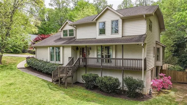 a view of a house with a yard chairs and a yard